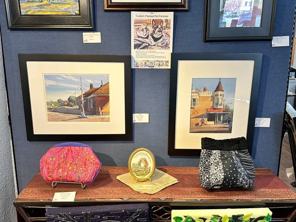 Framed paintings and textile artworks at Art Domestique gallery in Washington, IA