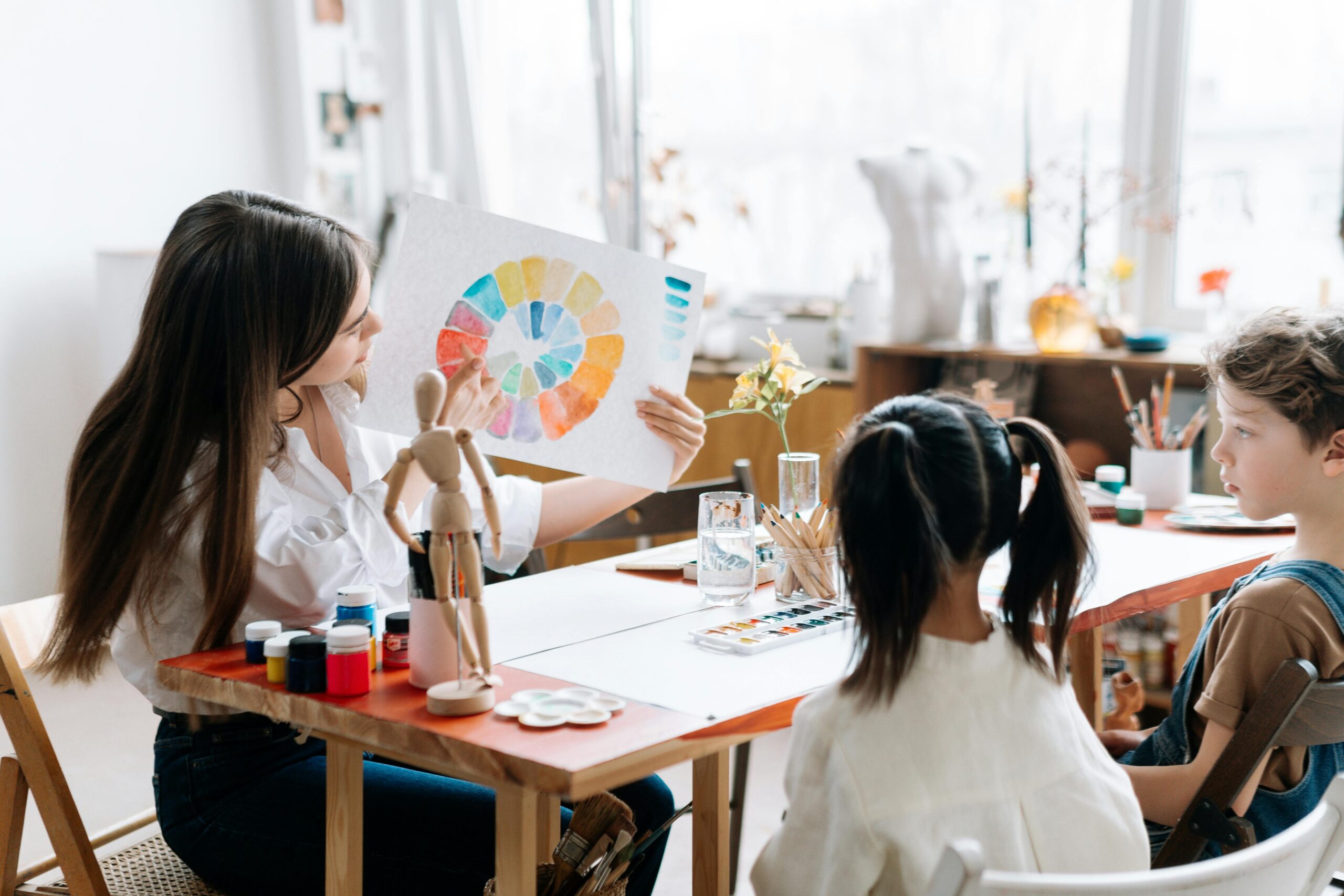 Stock photo of a teacher pointing at a color wheel